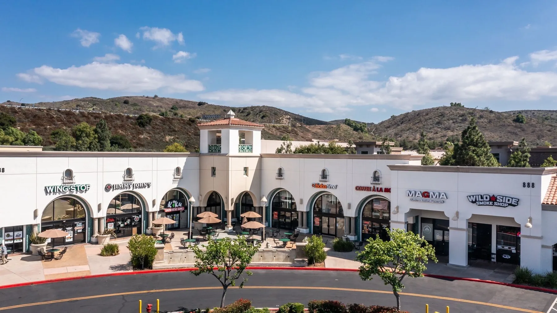 PacificWest managed retail center with Wingstop, landscaped walkways, and outdoor seating