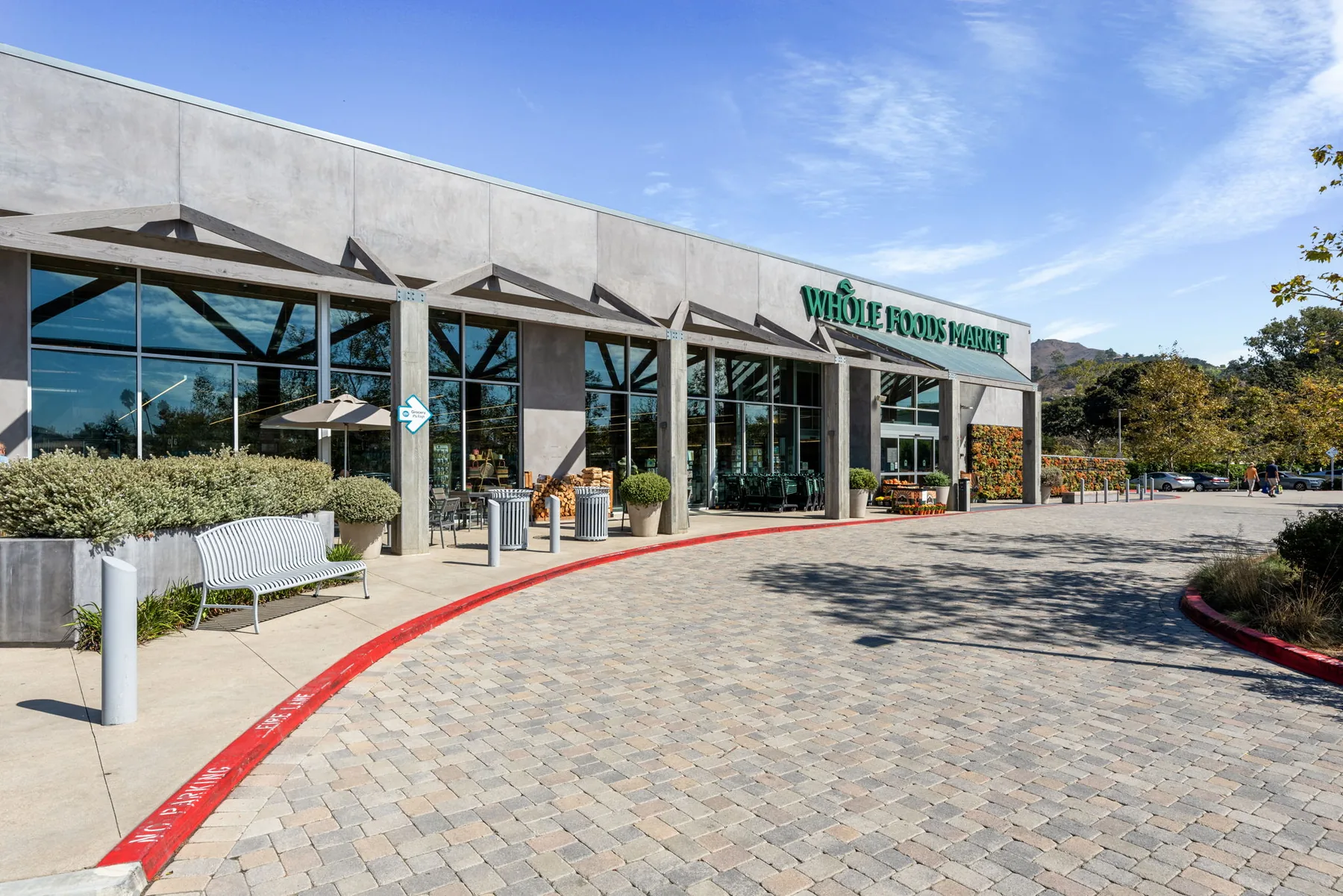 Well-kept pedestrian frontage at a managed grocery-anchored retail property
